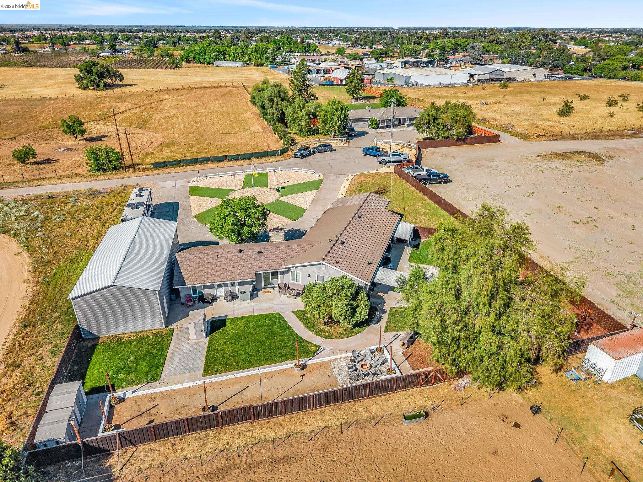 59 Old Stagecoach Road Brentwood, CA 94513 - Photo 67 of 70 Aerial view showcasing a single-story residence with a metal roof and an expansive concrete patio