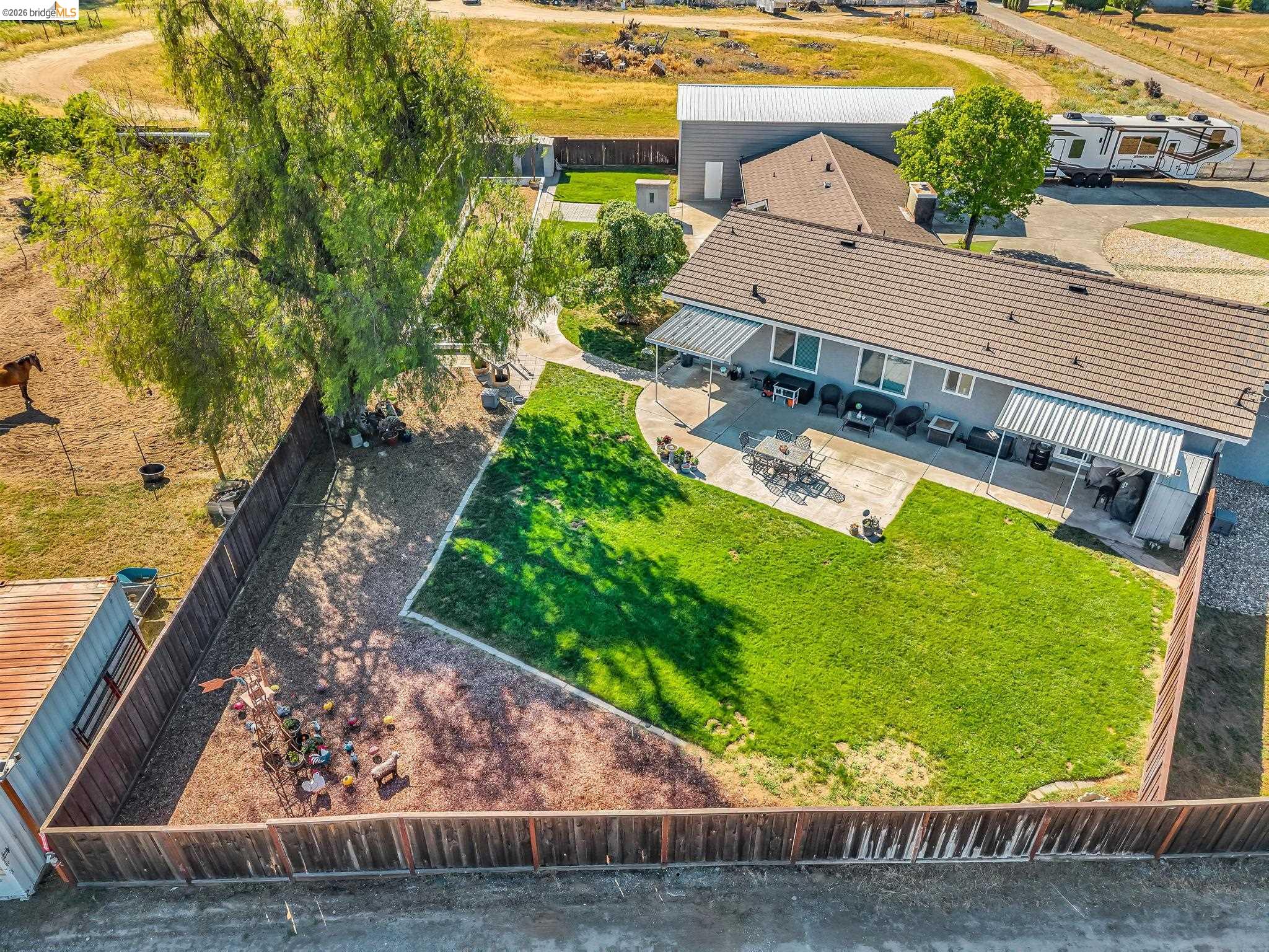 59 Old Stagecoach Road Brentwood, CA 94513 - Photo 69 of 70 Spacious backyard featuring a manicured lawn area, expansive concrete patio, and mature shade trees