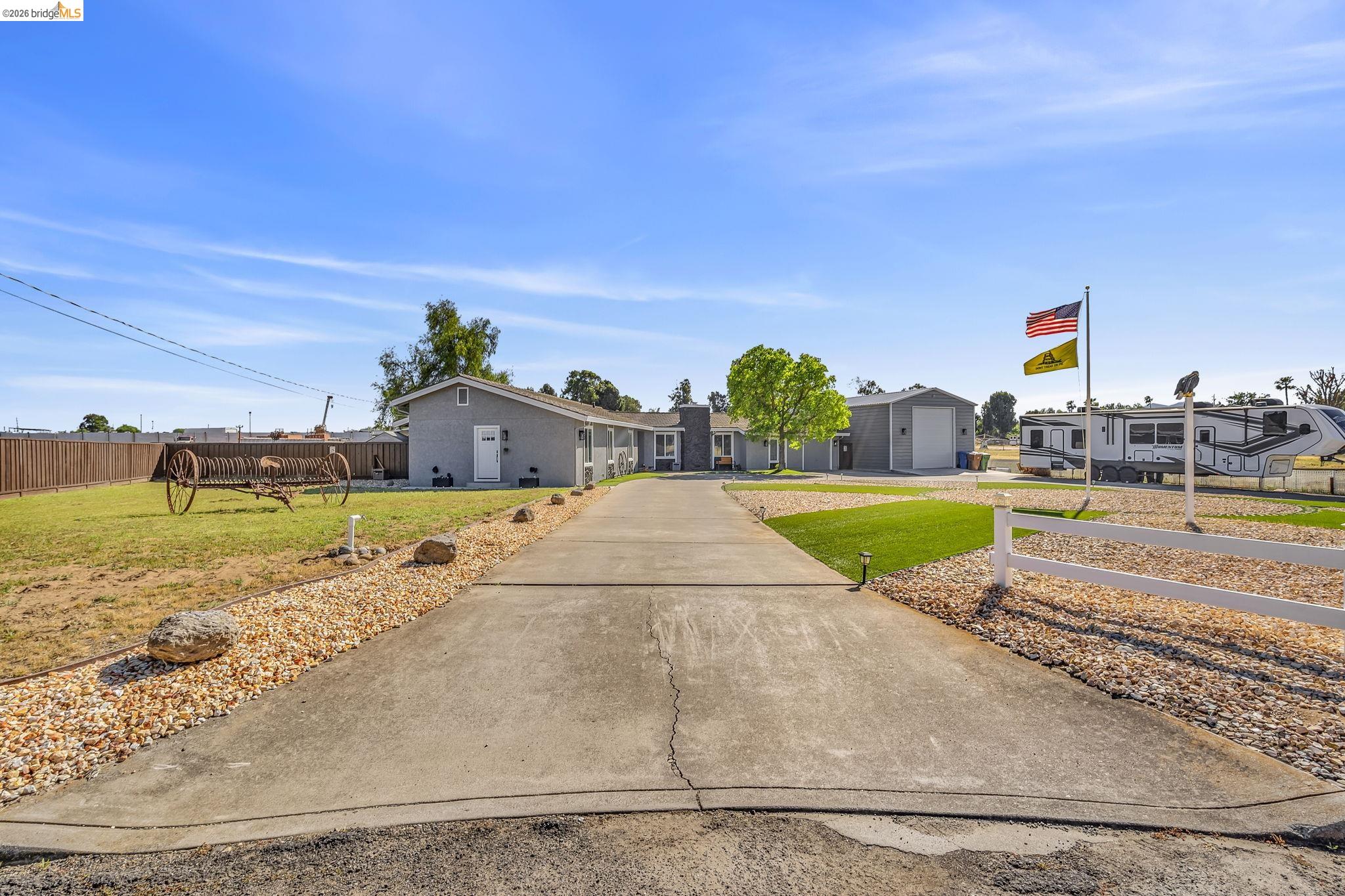 59 Old Stagecoach Road Brentwood, CA 94513 - Photo 7 of 70 Concrete driveway bordered by gravel and rock landscaping
