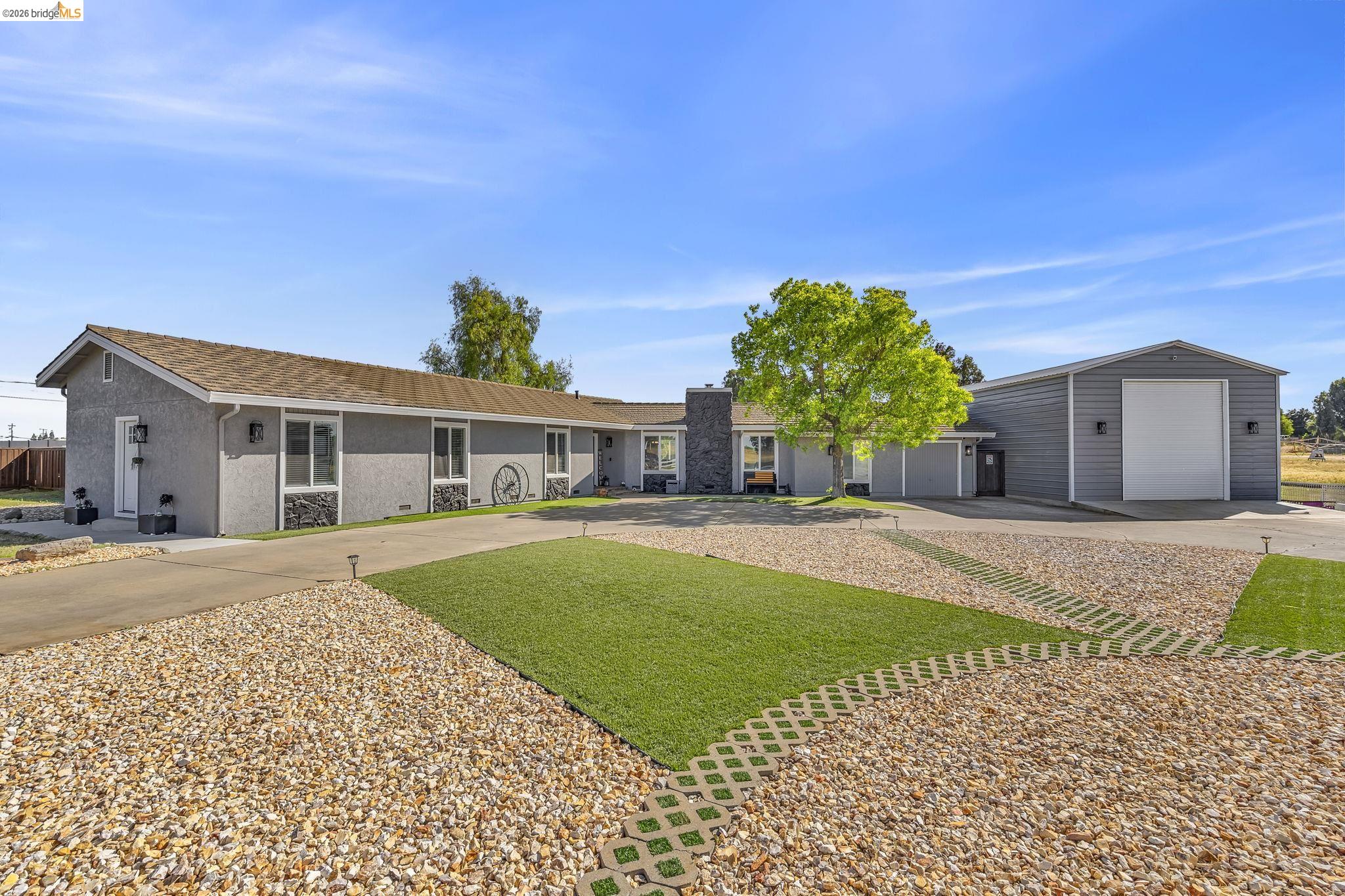 59 Old Stagecoach Road Brentwood, CA 94513 - Photo 9 of 70 Ranch-style exterior with a detached metal workshop featuring a roll-up door