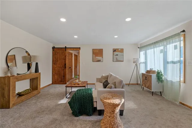 a living room with furniture a window and gym equipment