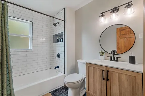 a bathroom with a sink a toilet and a mirror