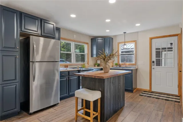 a kitchen with refrigerator and cabinets