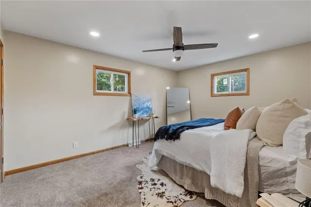 a bedroom with a bed and a painting on the wall