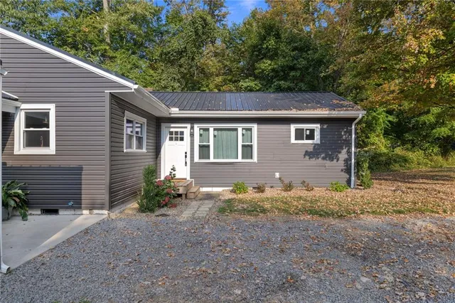 a backyard of a house with plants and trees