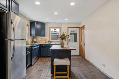 a kitchen with a refrigerator and a sink