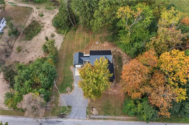 an aerial view of a house with a yard