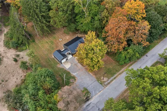an aerial view of a house with a yard