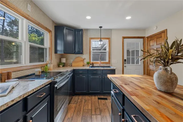 a kitchen with granite countertop lots of counter space and a sink