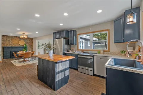 a kitchen with stainless steel appliances granite countertop a stove and a sink