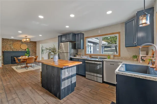 a kitchen with stainless steel appliances granite countertop a stove and a sink