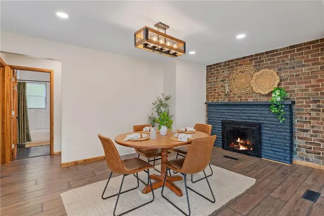 a dining room with furniture and a fireplace