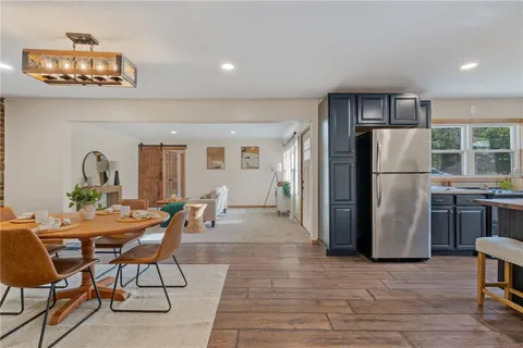 a kitchen with stainless steel appliances granite countertop a refrigerator and a stove top oven