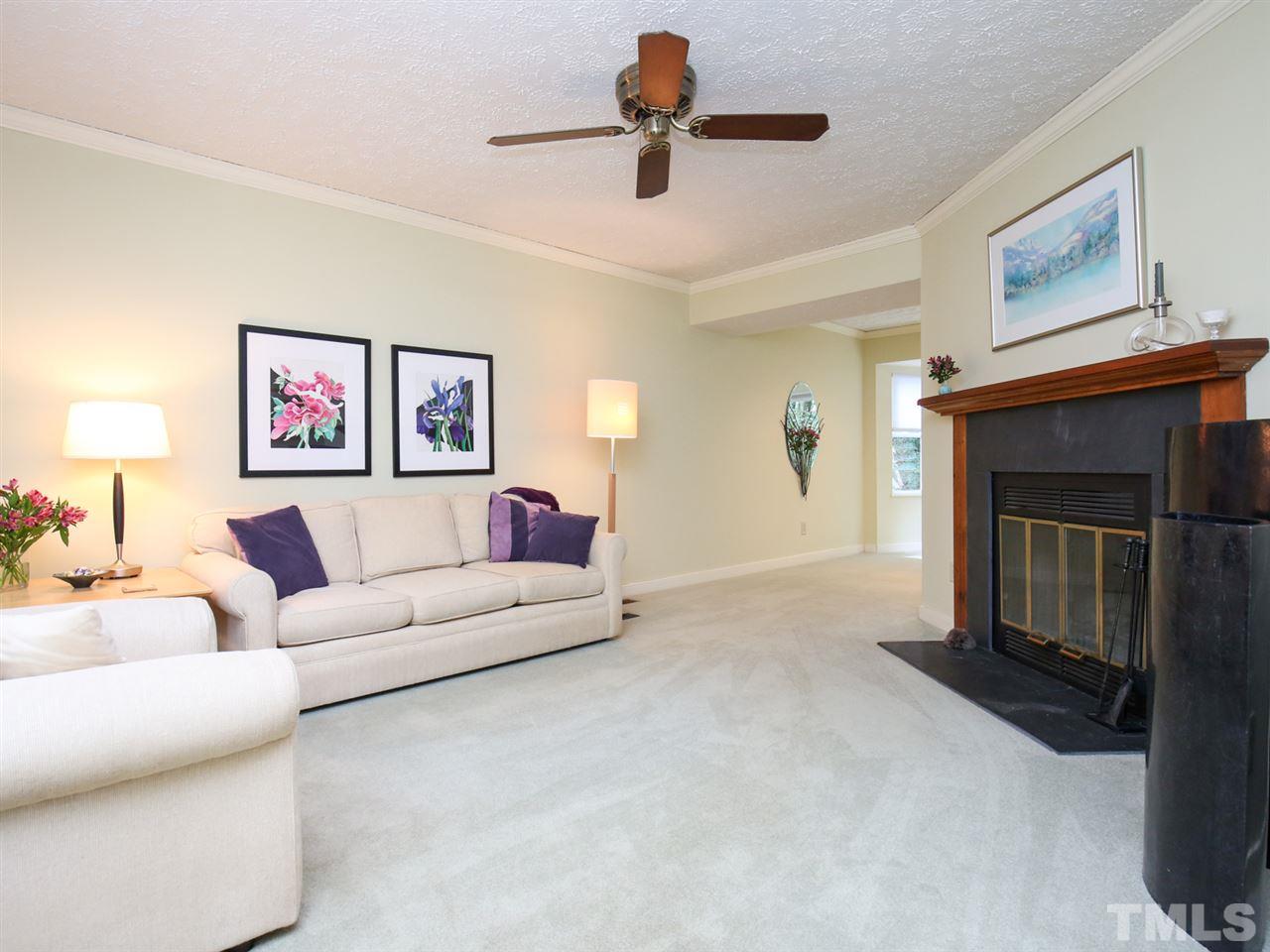 110 Trinity Woods Drive Raleigh, NC 27607 - Photo 3 of 30 a living room with furniture and a fireplace