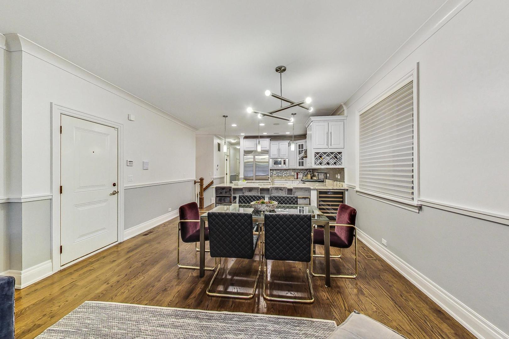 2848 North Sheffield Avenue, Unit 1N Chicago, IL 60657 - Photo 11 of 40 a view of a dining room with furniture and wooden floor