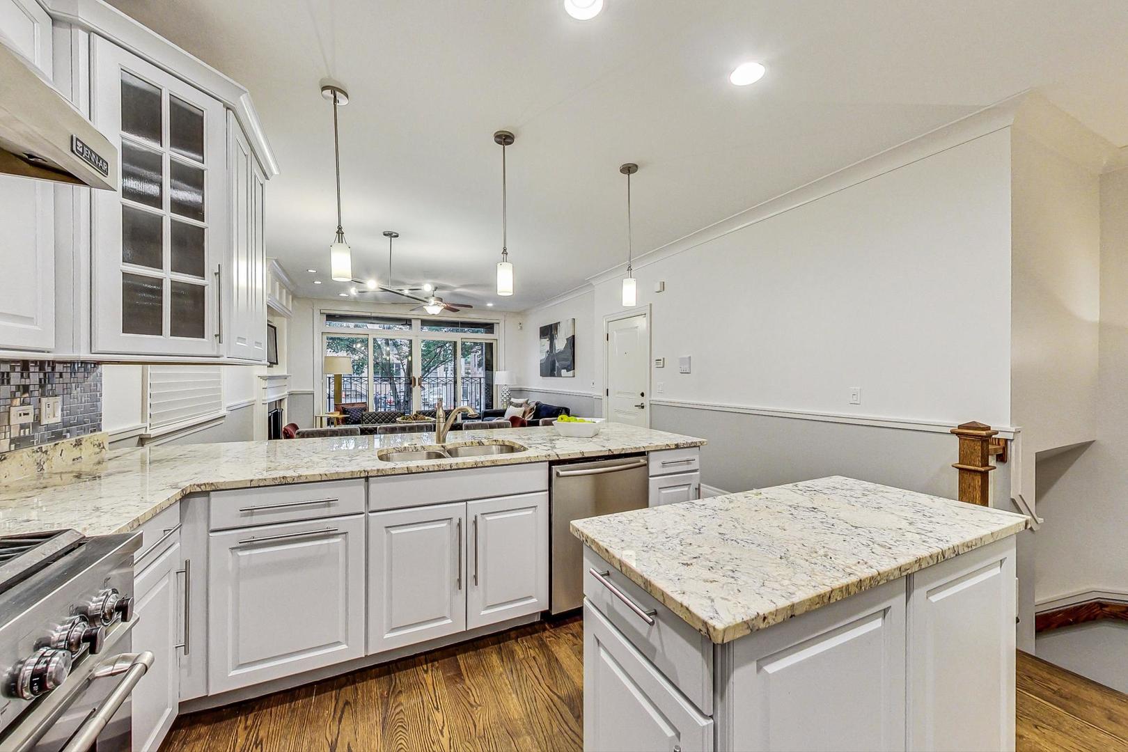 2848 North Sheffield Avenue, Unit 1N Chicago, IL 60657 - Photo 15 of 40 a kitchen with a sink dishwasher and white cabinets with wooden floor
