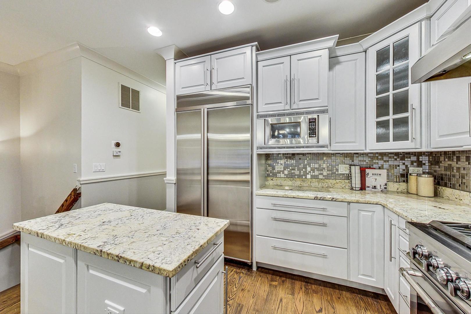 2848 North Sheffield Avenue, Unit 1N Chicago, IL 60657 - Photo 16 of 40 a kitchen with stainless steel appliances granite countertop a sink and cabinets