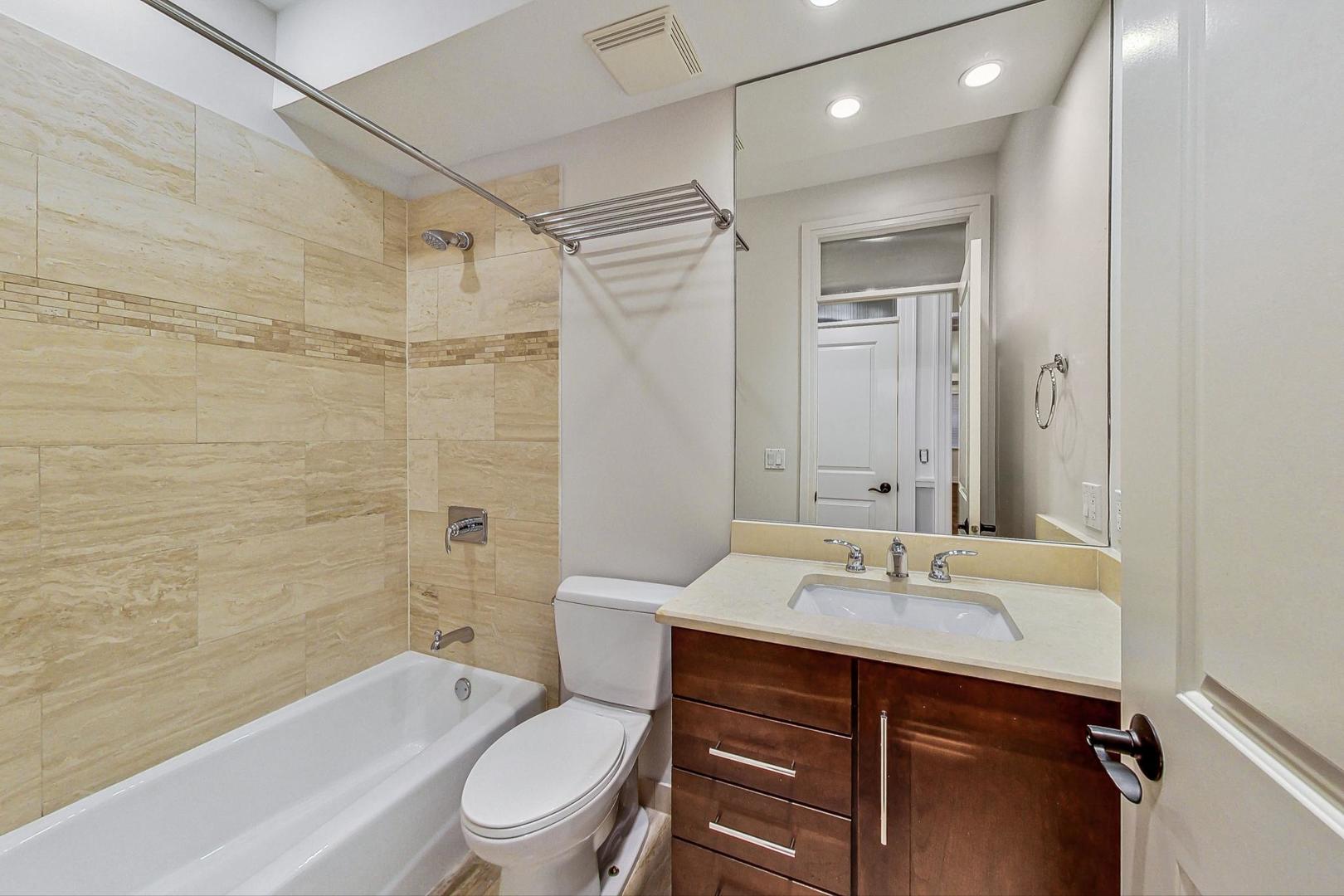 2848 North Sheffield Avenue, Unit 1N Chicago, IL 60657 - Photo 17 of 40 a bathroom with a sink toilet tub and shower