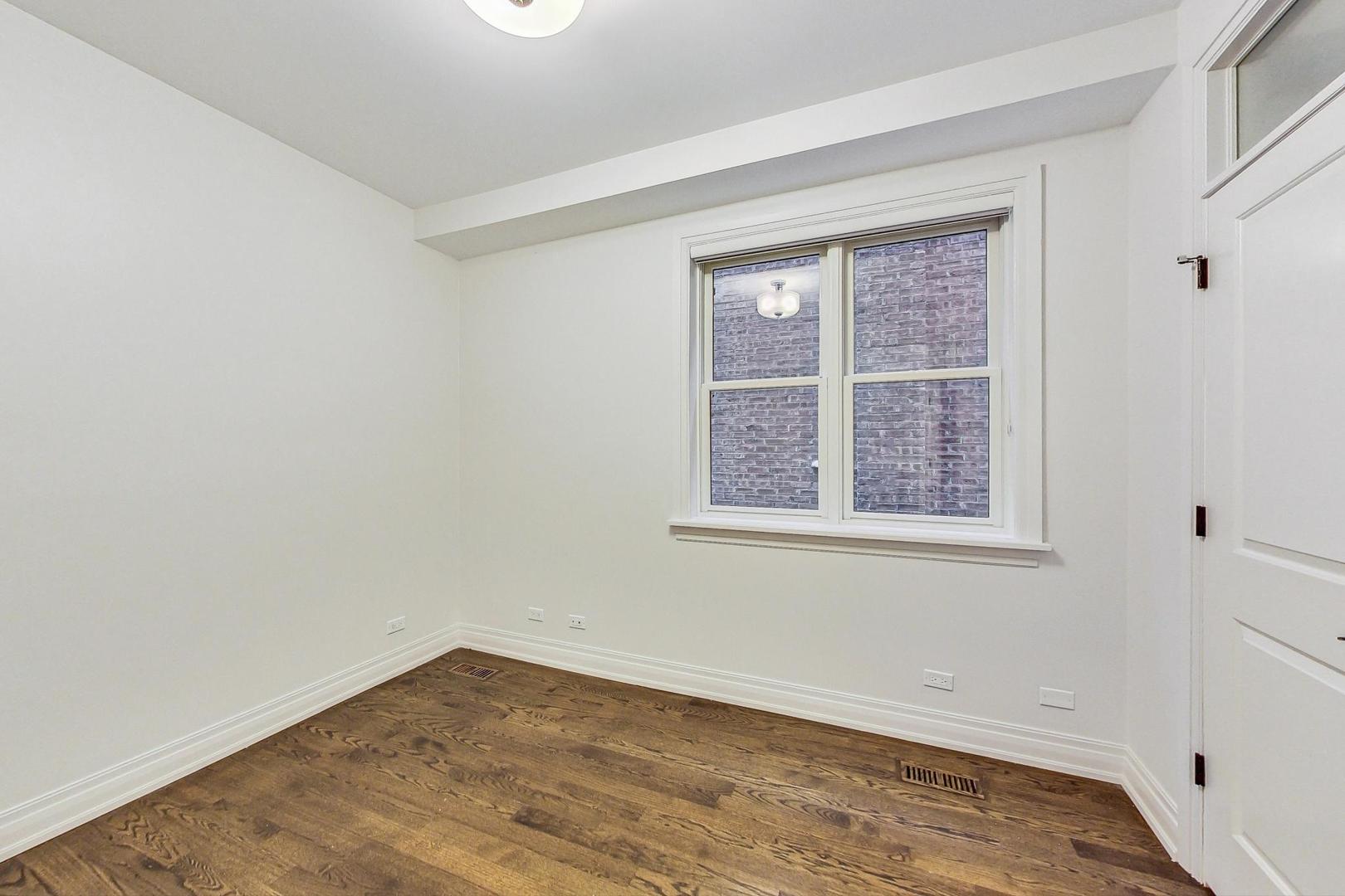 2848 North Sheffield Avenue, Unit 1N Chicago, IL 60657 - Photo 26 of 40 an empty room with a window