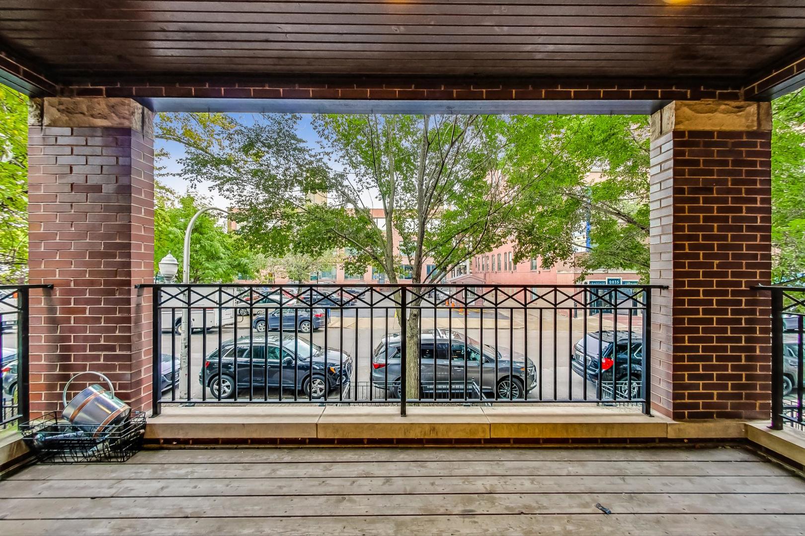 2848 North Sheffield Avenue, Unit 1N Chicago, IL 60657 - Photo 7 of 40 a view of a balcony with a floor to ceiling window next to a road