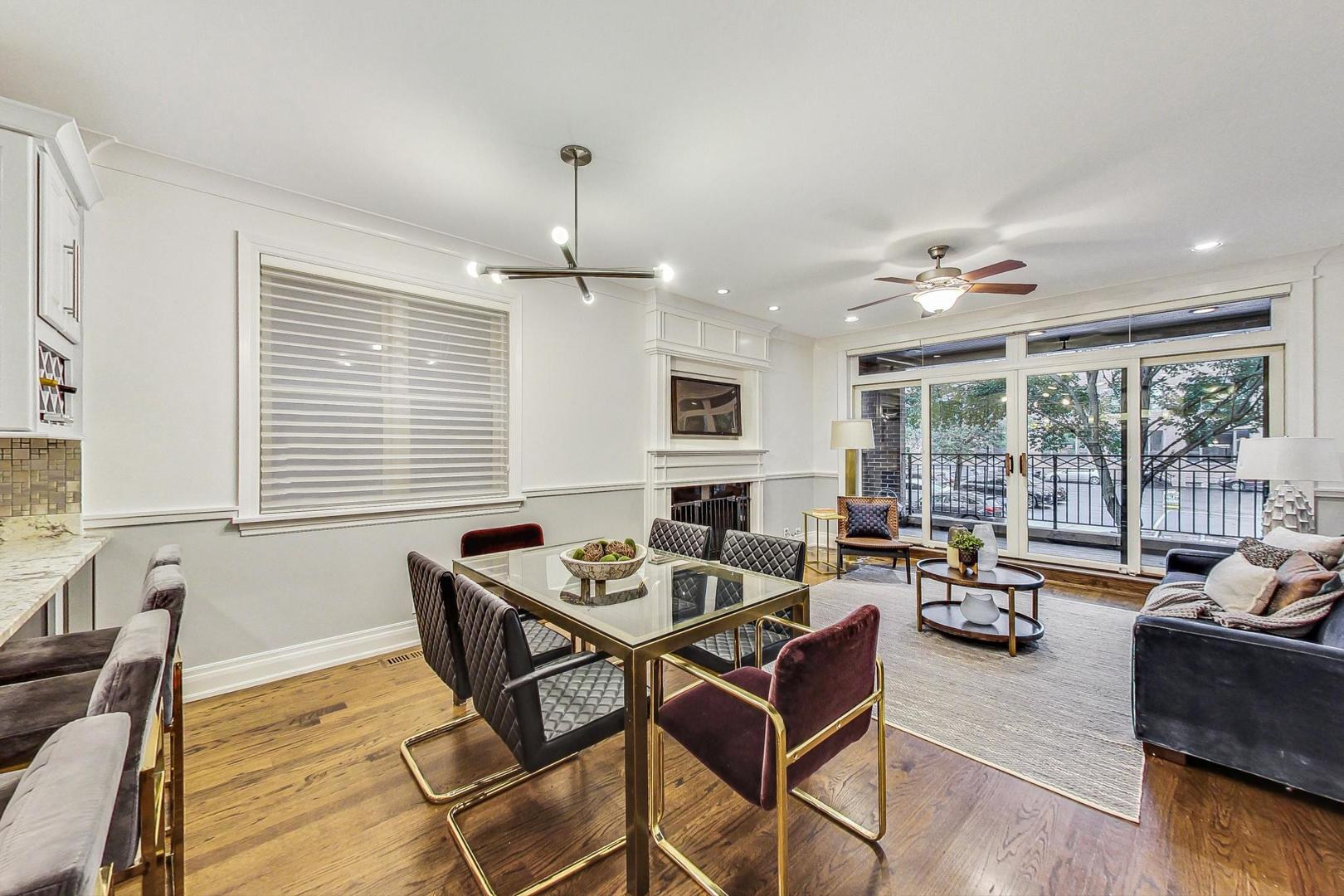2848 North Sheffield Avenue, Unit 1N Chicago, IL 60657 - Photo 10 of 40 a living room with furniture and floor to ceiling windows