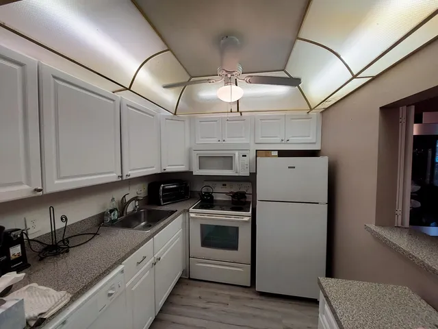 a kitchen with stainless steel appliances granite countertop a stove a refrigerator and a microwave