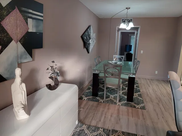 a view of a dining room with furniture and chandelier