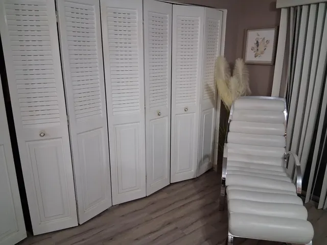 a view of a hallway with wooden floor and entryway