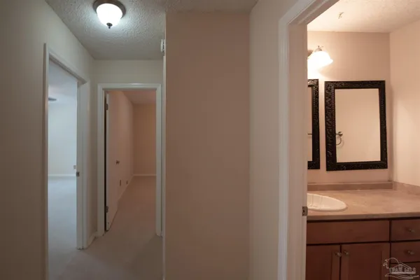 a bathroom with a granite countertop sink mirror vanity and toilet