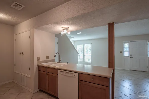 a view of a kitchen with a sink and cabinets