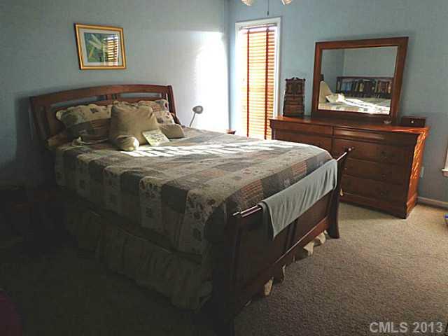 4102 Watson Church Road Monroe, NC 28110 - Photo 4 of 10 a bedroom with a bed and a flat tv screen on the dresser