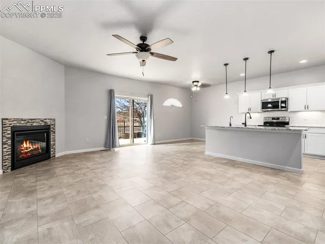a view of a kitchen with a sink and stainless steel appliances