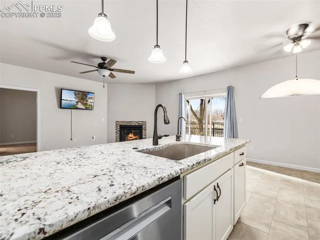 a kitchen with a refrigerator and white cabinets