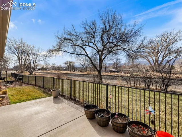 a backyard of a house with barbeque oven and outdoor seating