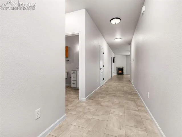 a view of a hallway with wooden shelves