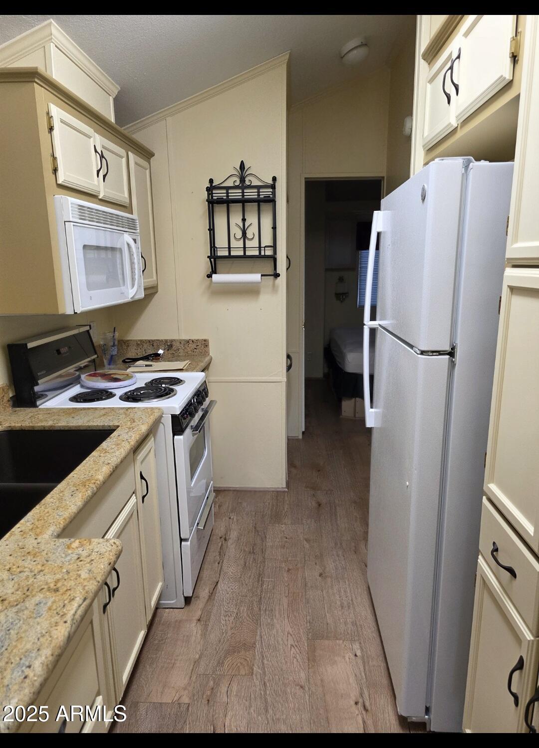 2359 East Pima Avenue Apache Junction, AZ 85119 - Photo 13 of 24 a kitchen with a refrigerator sink stove and cabinets