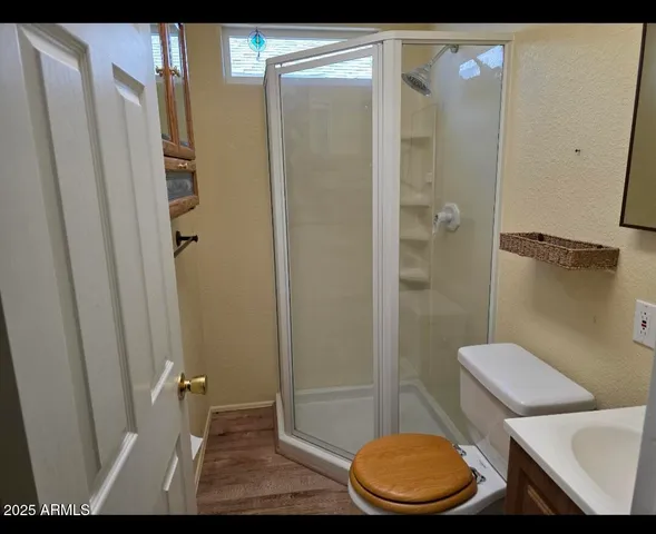 a bathroom with a granite countertop toilet and a sink