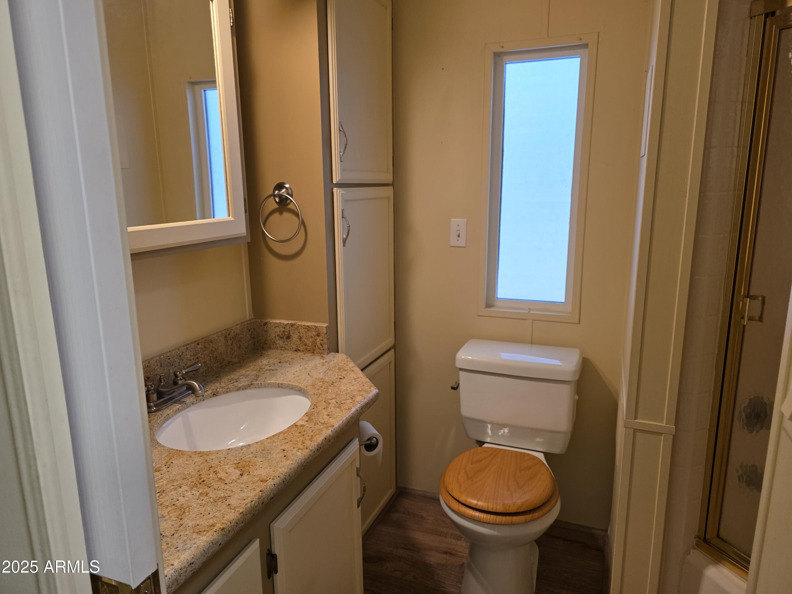 2359 East Pima Avenue Apache Junction, AZ 85119 - Photo 15 of 24 a bathroom with a granite countertop toilet and a sink