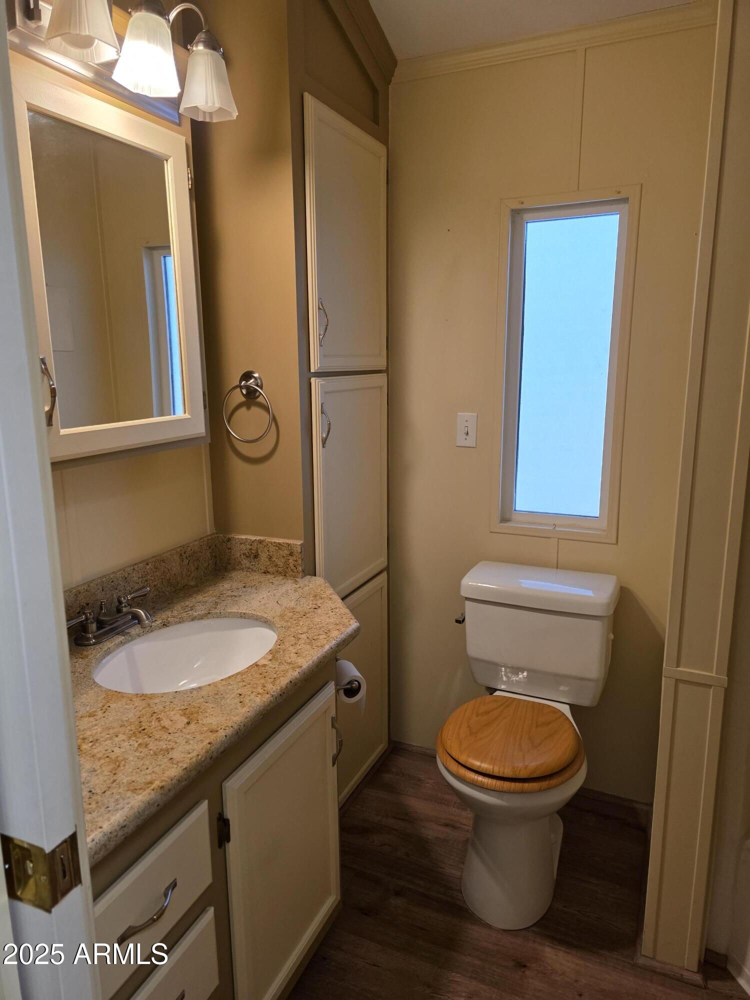 2359 East Pima Avenue Apache Junction, AZ 85119 - Photo 16 of 24 a bathroom with a granite countertop toilet sink and mirror