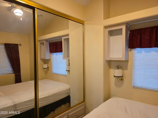 a bedroom with a bed and cabinets