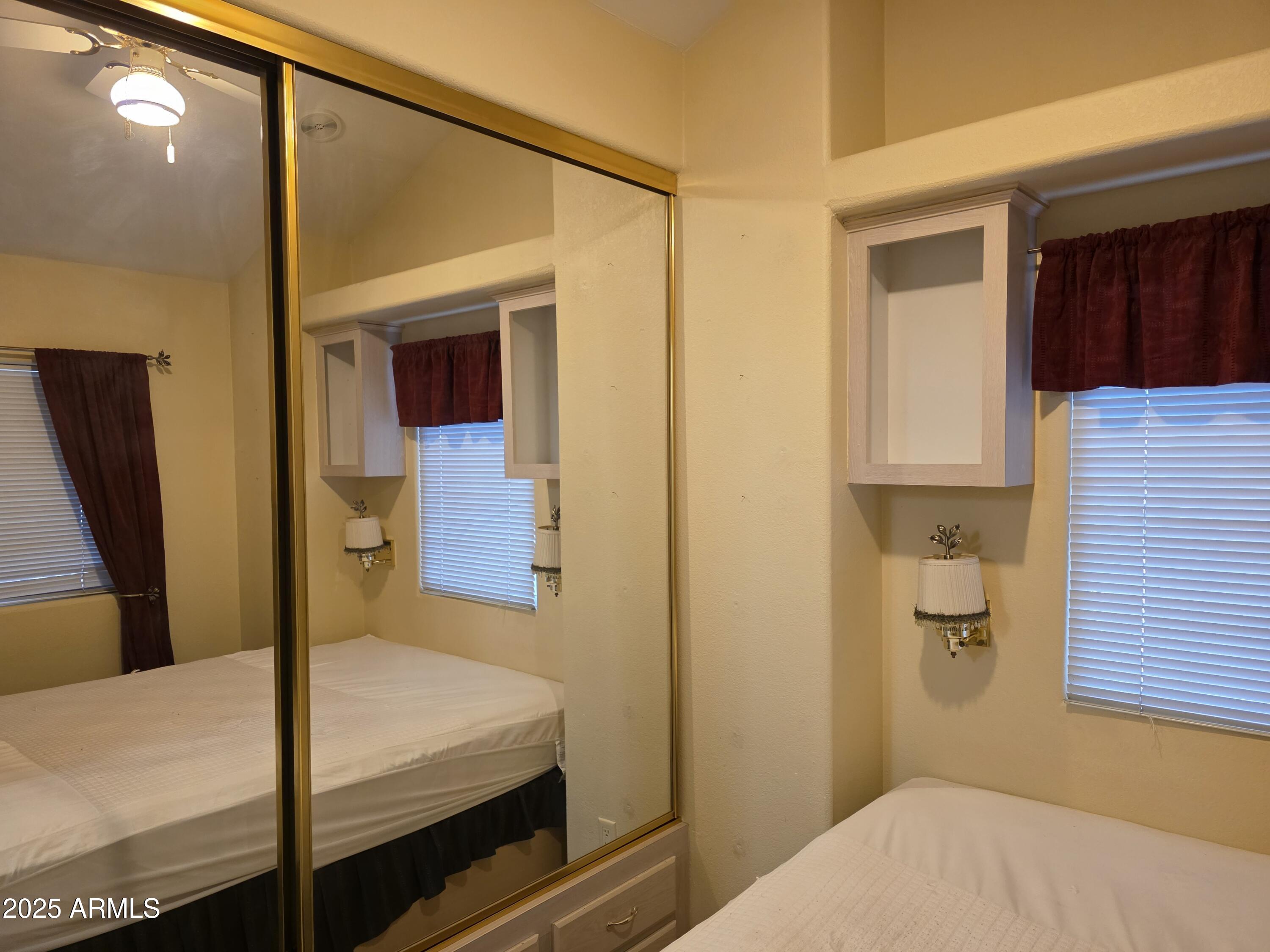 2359 East Pima Avenue Apache Junction, AZ 85119 - Photo 17 of 24 a bedroom with a bed and a mirror