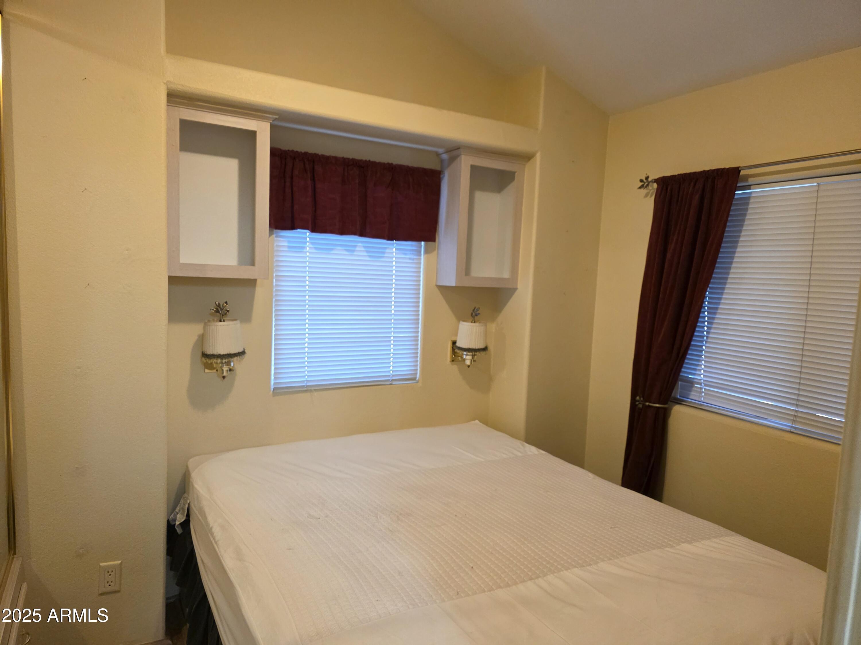 2359 East Pima Avenue Apache Junction, AZ 85119 - Photo 18 of 24 a bedroom with a bed and cabinets