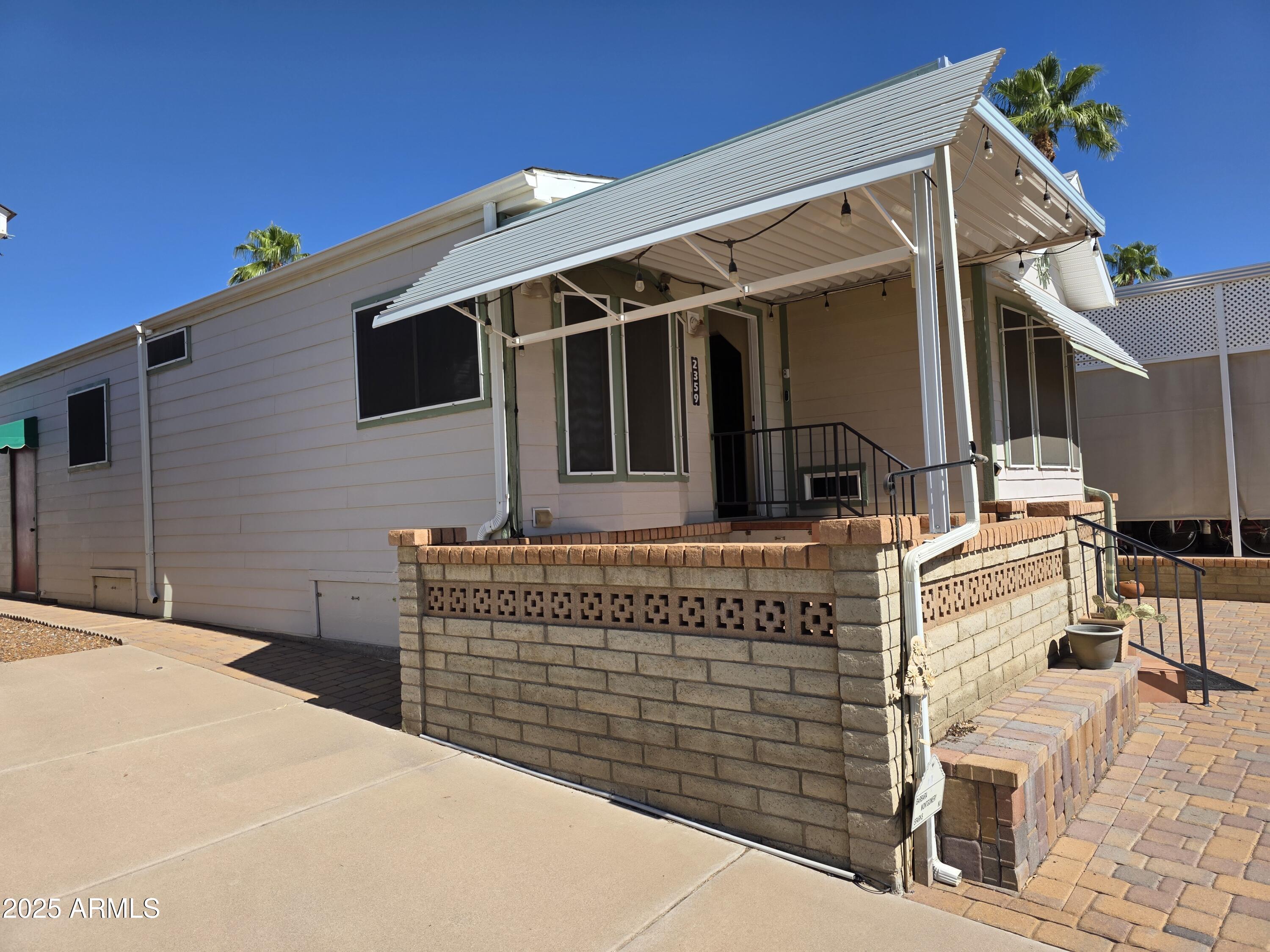 2359 East Pima Avenue Apache Junction, AZ 85119 - Photo 4 of 24 a front view of a house with large windows