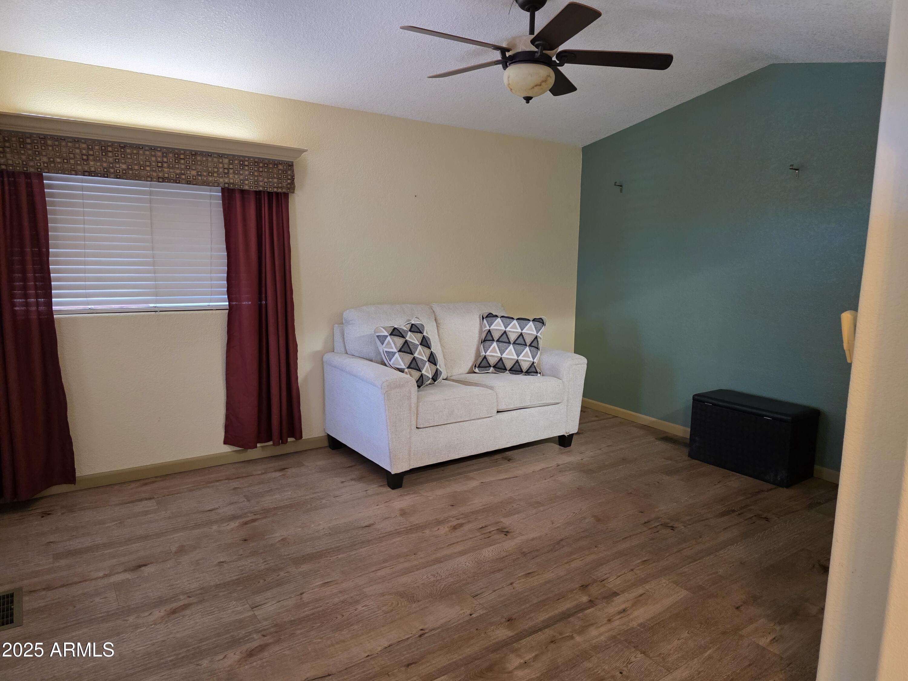 2359 East Pima Avenue Apache Junction, AZ 85119 - Photo 7 of 24 a view of a livingroom with wooden floor and ceiling fan