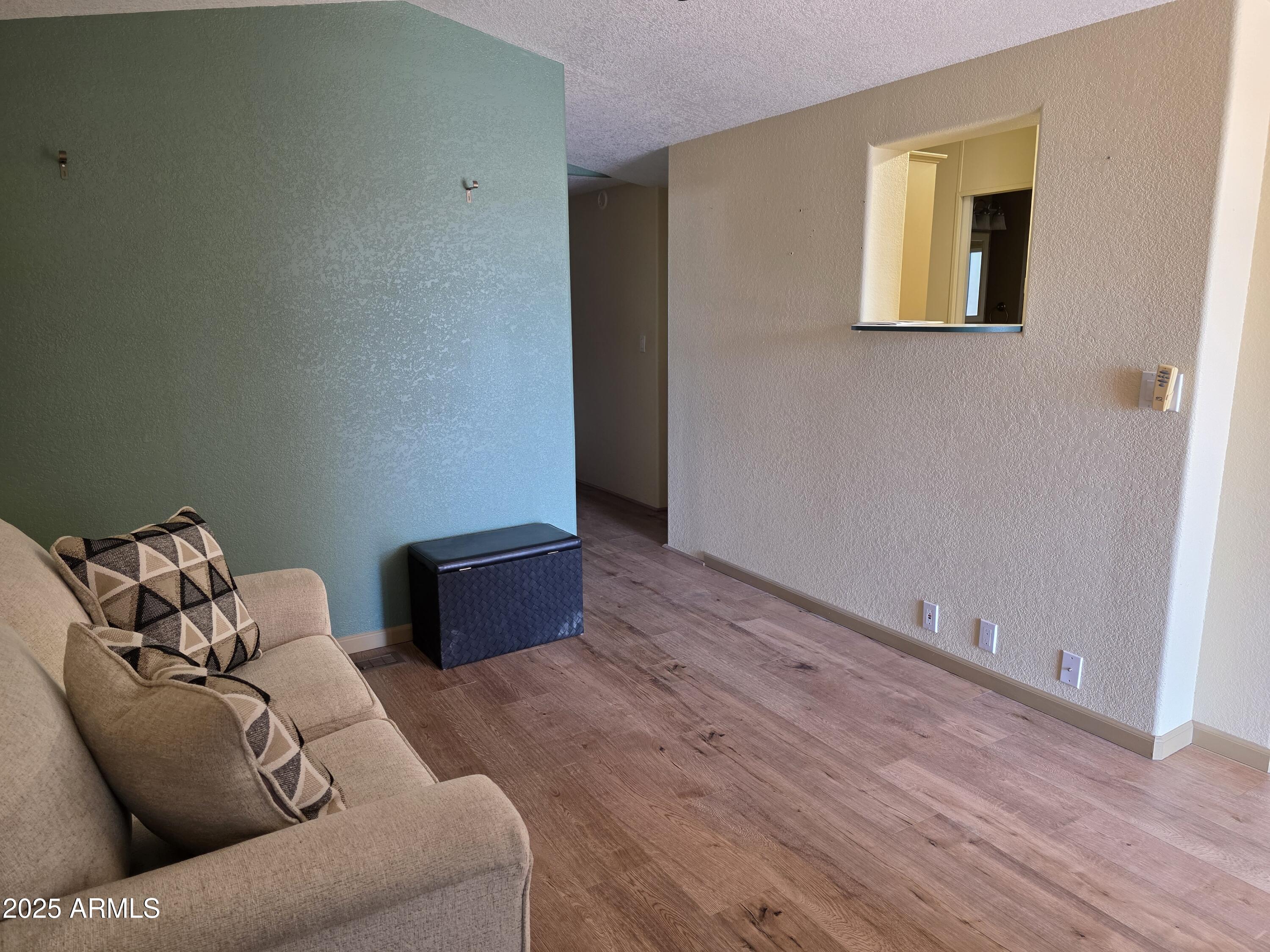 2359 East Pima Avenue Apache Junction, AZ 85119 - Photo 8 of 24 a living room with furniture and a wooden floor