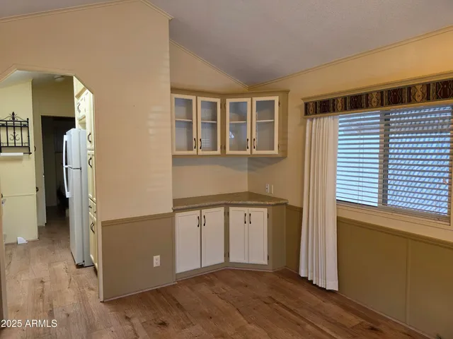 a very nice looking room with wooden floor and a window