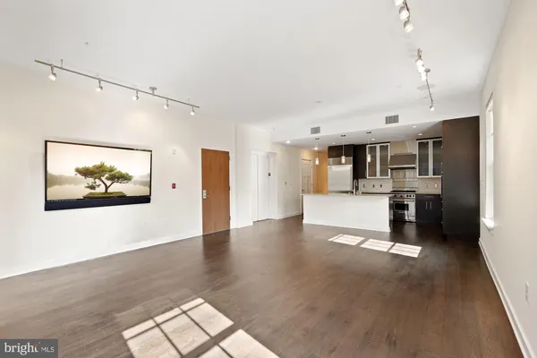 a view of kitchen with cabinets and wooden floor