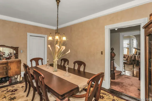 a view of a dining room with furniture and chandelier