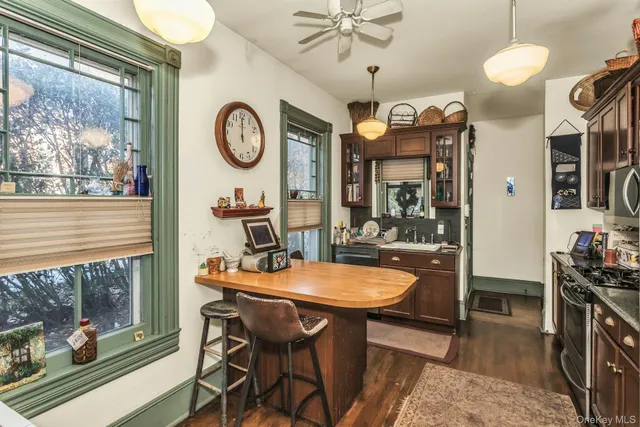 a view of a dining room with furniture a chandelier and wooden floor