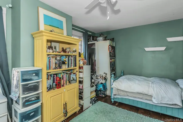 a bedroom with a bed and a book shelf